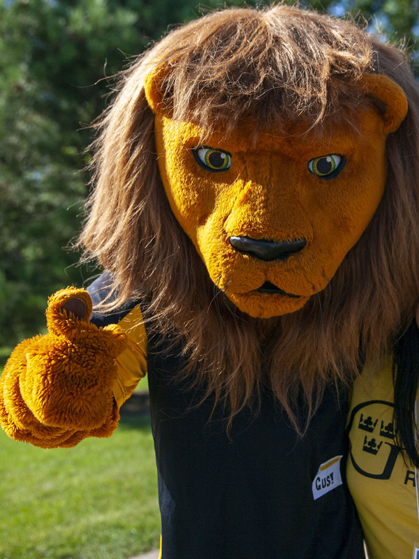 Gus the Lion with a student.