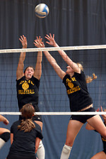 Senior Bridget Burtzel and junior Meghan Gehring go up for the block.