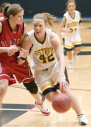 Sophomore Vicky Peterson drives toward the hoop.