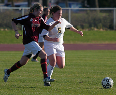 Shannon Quealy races an Auggie to the ball.