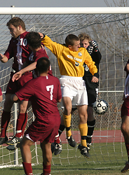 Ryan Beduhn shields Hamline goalkeeper Clement as Dan Suchy's corner kick drops into the net for the Gusties second goal.