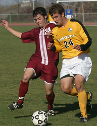Alex Groth battles a Piper defender for possession.